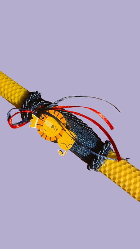 Easter colored candle with wooden lion