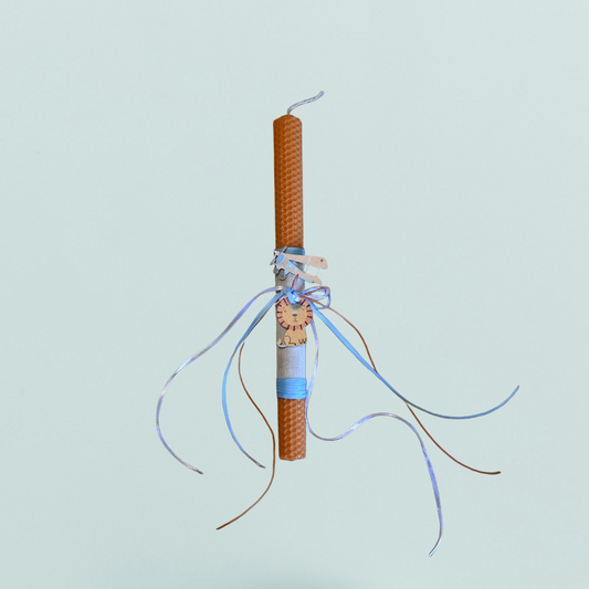 Easter colored candle with wooden lion