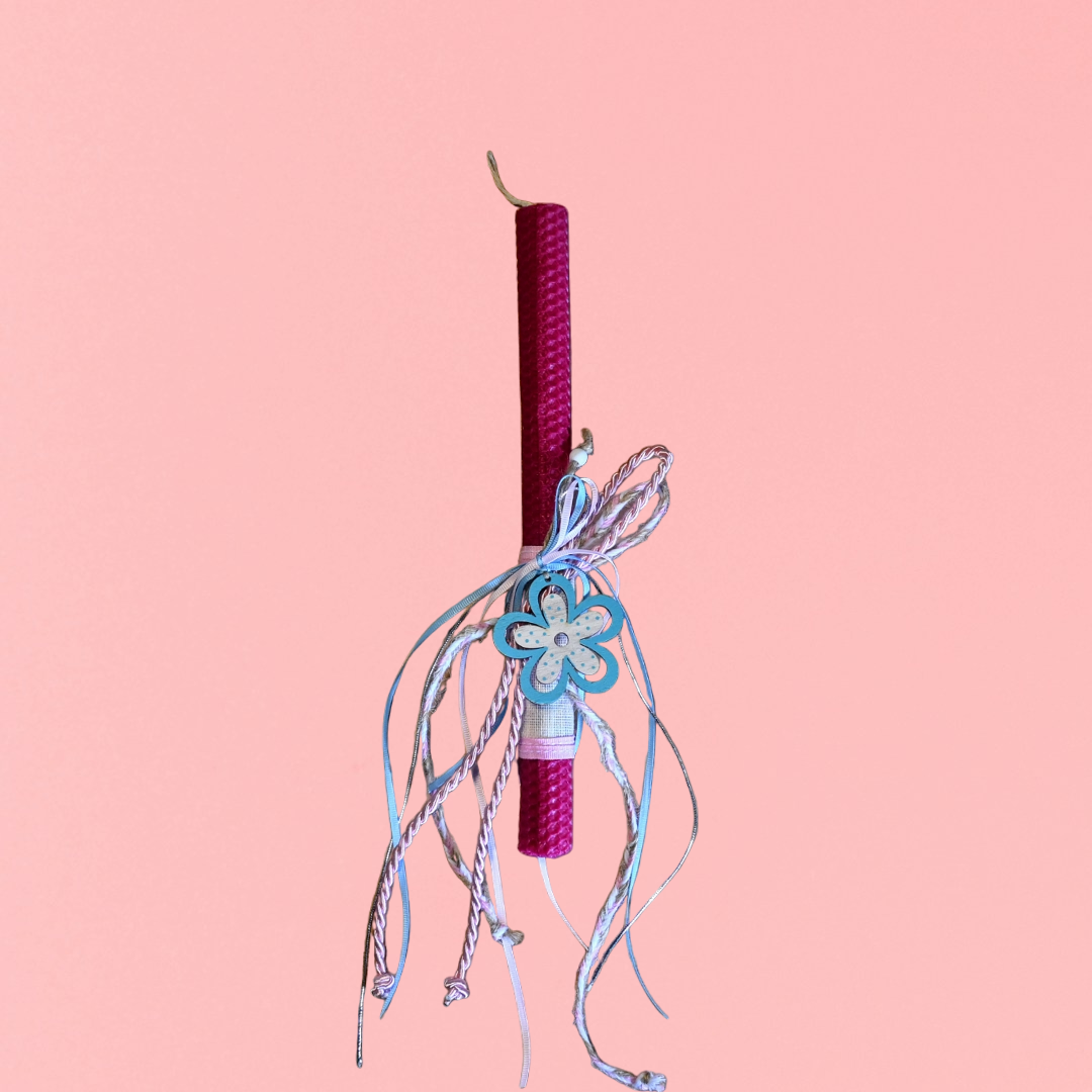 Easter colored candle with wooden decorative flower